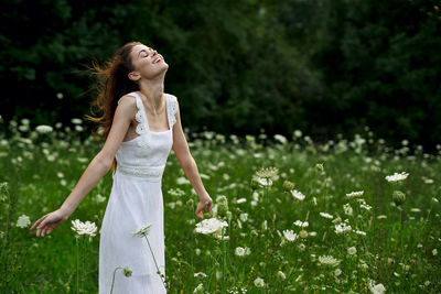 Young woman with flower petals on field