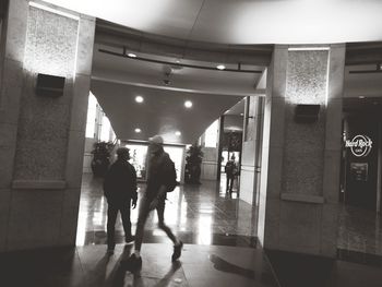 People walking in illuminated building