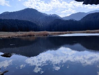 Scenic view of lake and mountains against sky