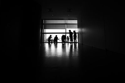 Silhouette people in corridor of building