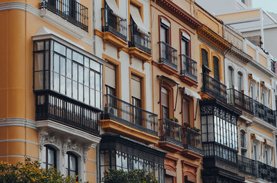 Close up of a row of traditional apartment blocks on a street in seville, andalusia, spain.