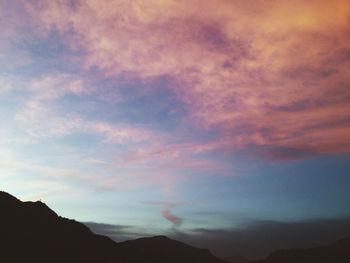 Scenic view of mountains against cloudy sky