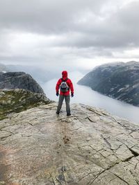 Full length of man standing on mountain against sky