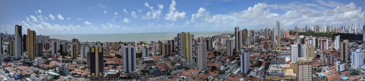 Panoramic view of modern buildings in city against sky