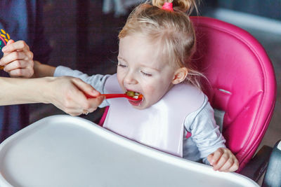 Close-up of boy blowing bubbles at home