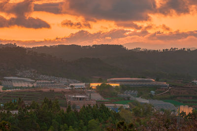 High angle view of townscape against orange sky