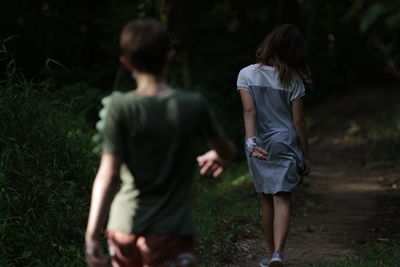 Couple walking on footpath in forest