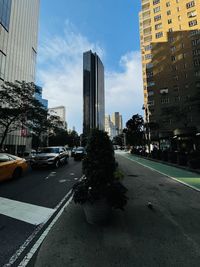 City street and buildings against sky