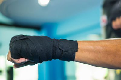 Cropped image of man wearing boxing glove