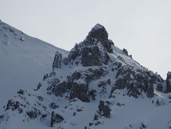 Low angle view of snowcapped mountain against sky