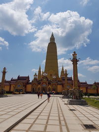 Group of people in front of building against sky