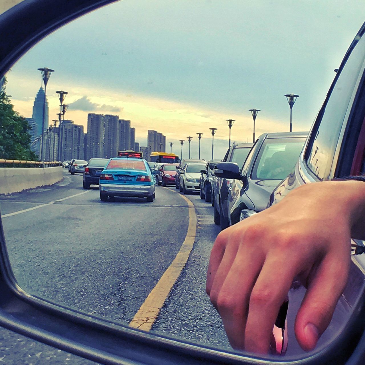 transportation, mode of transport, land vehicle, sky, part of, cropped, lifestyles, road, leisure activity, personal perspective, cloud - sky, cloud, city, day, unrecognizable person, outdoors, journey