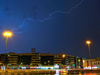 Low angle view of illuminated buildings against sky at night