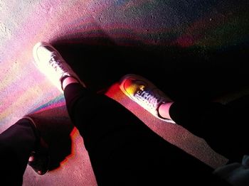 Low section of woman standing on tiled floor