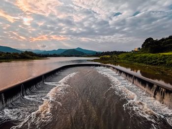 Scenic view of river against sky during sunset