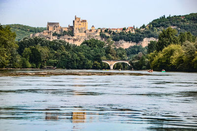 View of bridge over river against buildings