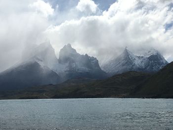 Scenic view of lake and mountains against sky