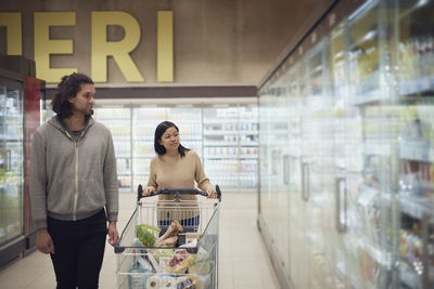 Couple in supermarket doing shopping together