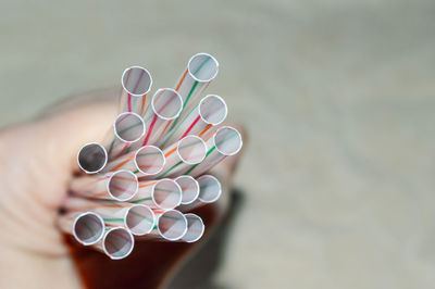 High angle view of human hand holding paper