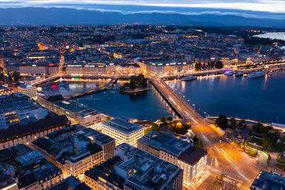 High angle view of illuminated city street and buildings at night