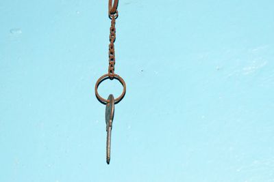 Close-up of chain against blue water