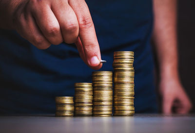 Cropped image of hand holding stack of coins