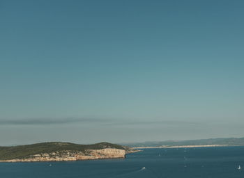 Scenic view of sea against clear blue sky