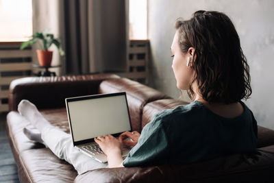 Young woman using digital tablet at home