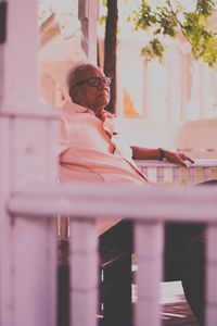 Midsection of woman standing by railing
