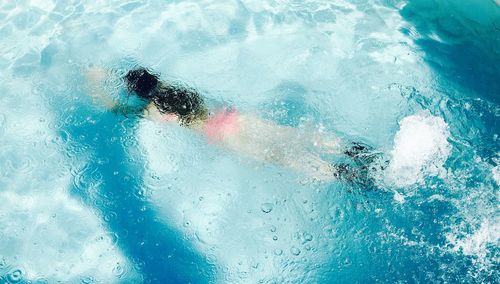 High angle view of woman swimming in pool