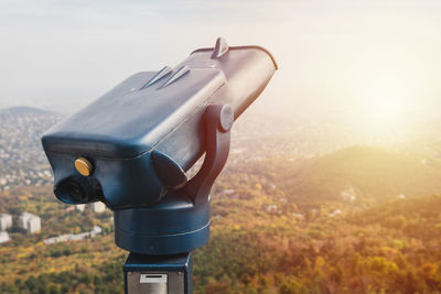 Close-up of camera on landscape against sky