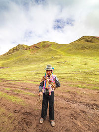 Full length of man standing on mountain against sky