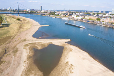 High angle view of sea and city against sky