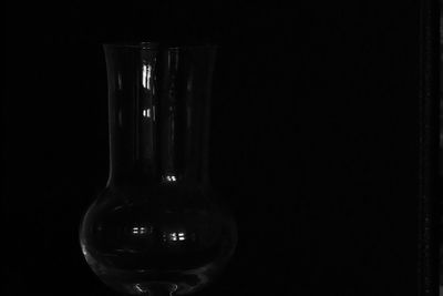 Close-up of wine glass against black background