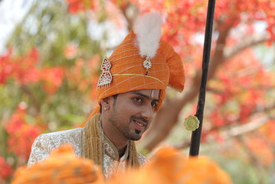 Close-up of bridegroom wearing turban while looking away