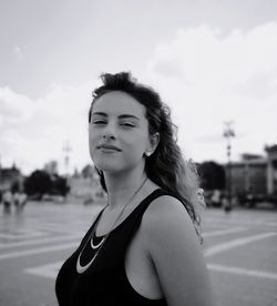 Portrait of young woman against sky