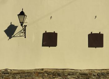 Low angle view of street light against building