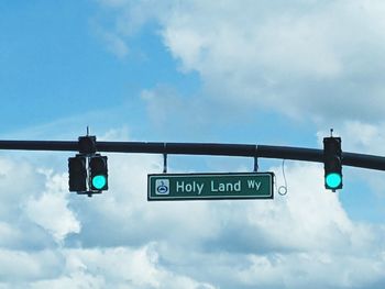 Low angle view of road signs against sky