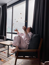 Man sitting on chair at home