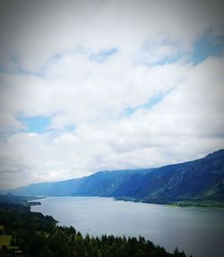 Scenic view of lake against cloudy sky