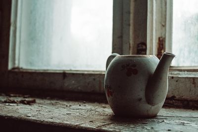 Close-up of window on table against wall