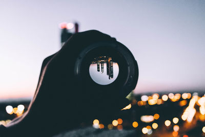 Close-up of camera against clear sky at dusk