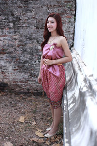 Portrait of a smiling young woman standing outdoors