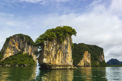 Panoramic view of rock formation in sea against sky