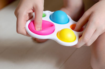 Close-up of a simple dimple in the hands of a child. a child plays with a modern toy simple dimple