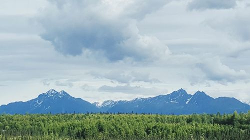 Scenic view of mountains against cloudy sky