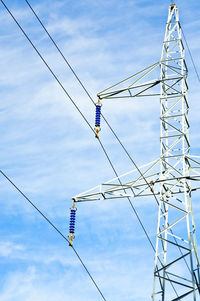 Low angle view of cables against blue sky