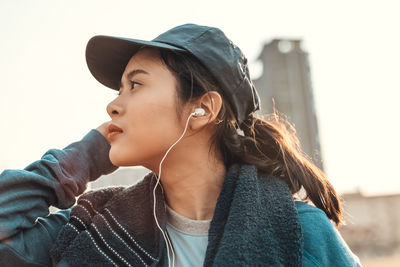 Portrait of young woman looking away outdoors