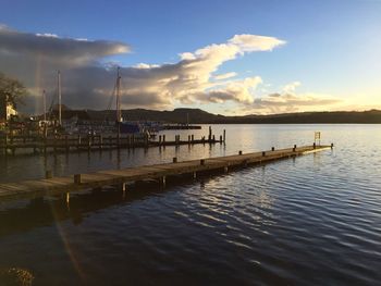 Pier at lakeside against sky