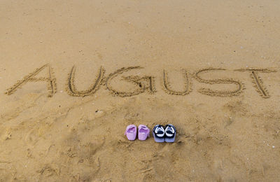 High angle view of text on sand